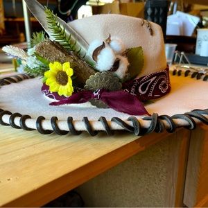 Beautiful handcrafted flat brimmed hat made with real feathers and tree bark.